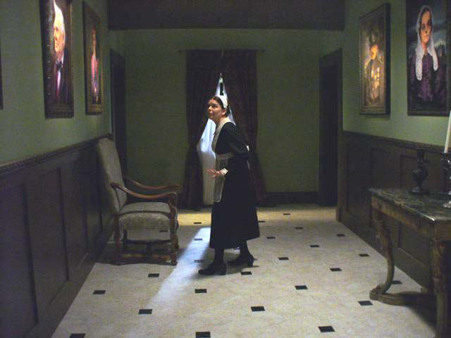 Here's another area on the old Cavinder Mansion set where the portraits were hung...here being apprehensively beheld by Trish Geiger playing the maid, Jane Hovenham. Photograph courtesy Trish Geiger.